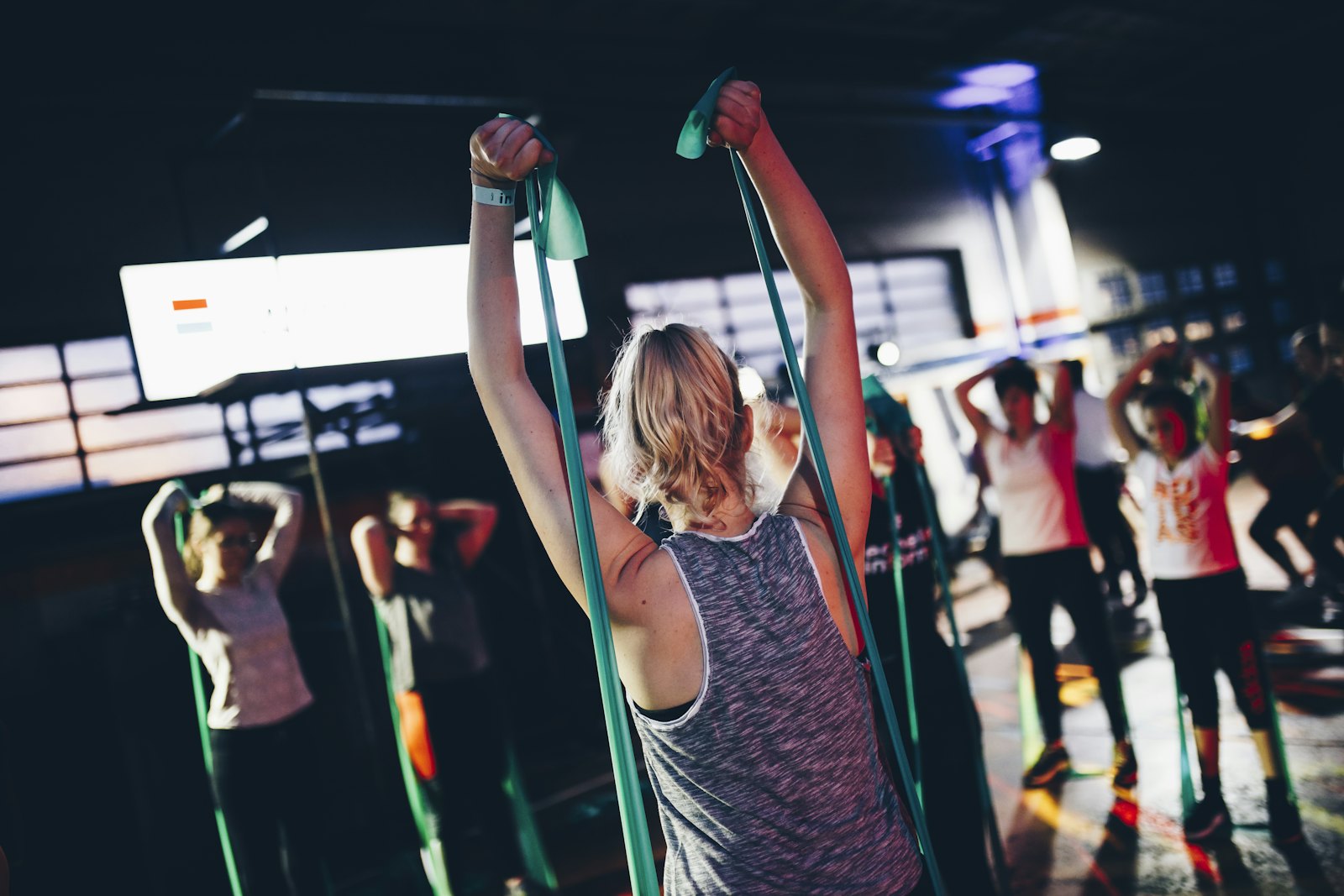 A group class working out together under low light