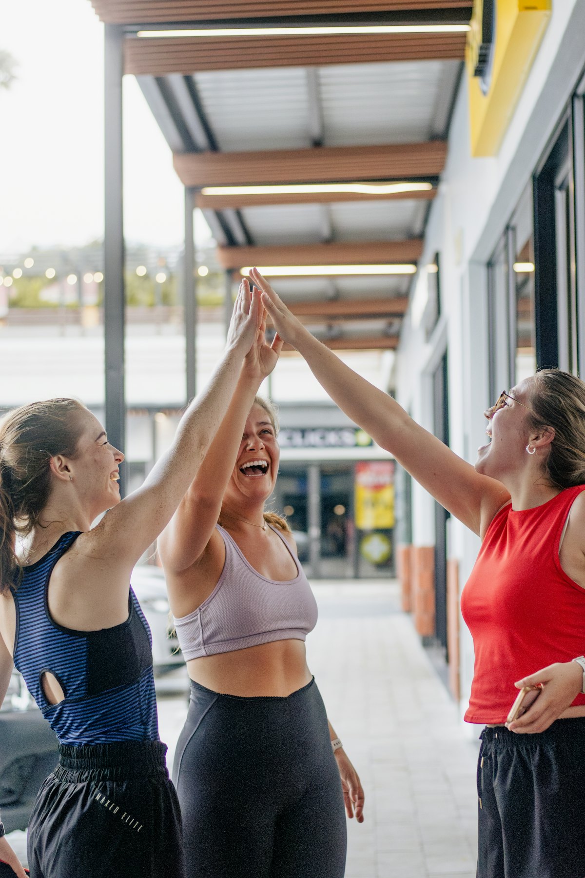 Three women laughing and high-fiving