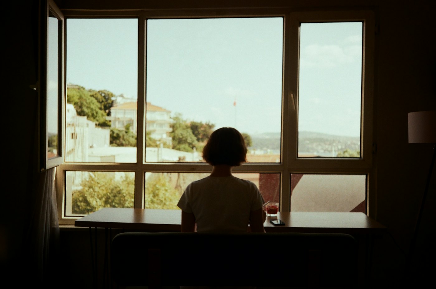 One person sitting alone at a window