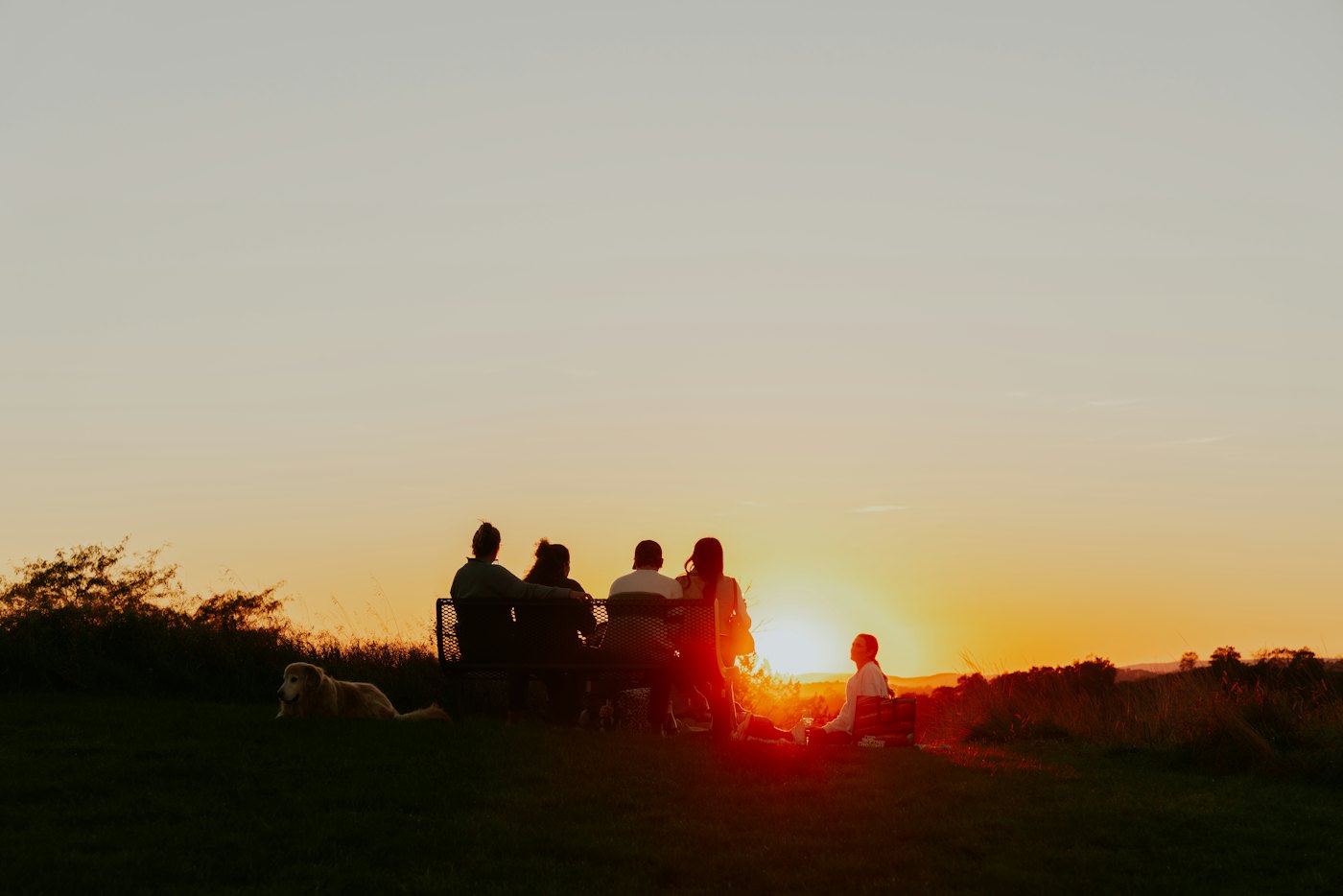 A group of friends together at sunset